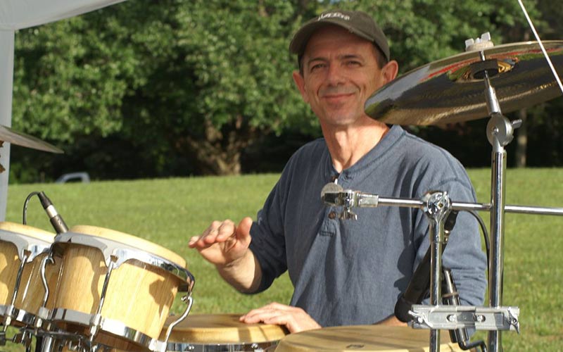 Kevin Doxzen web designer playing congas in a band.