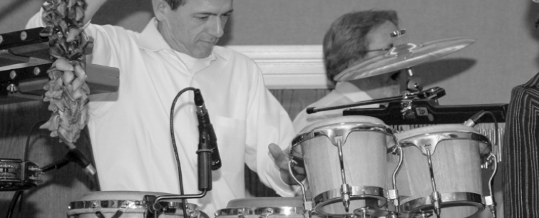 Kevin Doxzen web designer playing congas in a band.